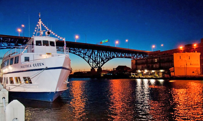 Photo of the Nautica Queen on the river at night