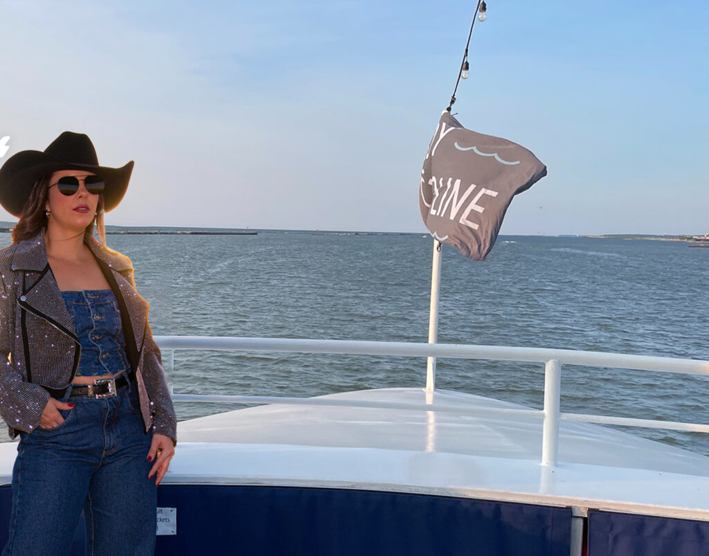 Woman standing on Lady Caroline Dining Cruise Ship for Country Night.