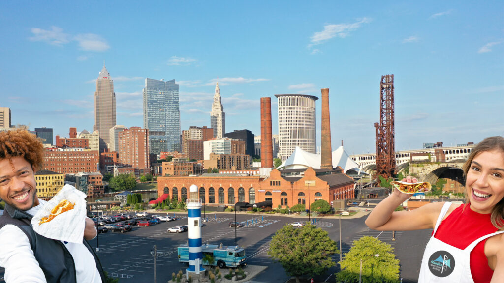 Two people holding food truck food in front of the Powerhouse.